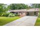 A well maintained front yard and long driveway highlight this single story red brick home at 3854 Ridgewood Se Dr, Smyrna, GA 30080