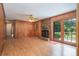 Cozy living room with brick fireplace, wood paneling, and access to backyard at 3854 Ridgewood Se Dr, Smyrna, GA 30080