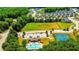 Aerial view showcases community amenities: a swimming pool, clubhouse, playground, sports field, and tennis courts at 4220 Sawgrass Dr, Lithonia, GA 30038