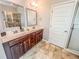 This bathroom has tile flooring, a double sink vanity, and a glass shower at 4220 Sawgrass Dr, Lithonia, GA 30038