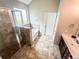 This bathroom has tile flooring, a soaking tub, glass shower, and a single sink vanity at 4220 Sawgrass Dr, Lithonia, GA 30038