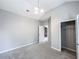 This bedroom has carpet flooring, base molding, a modern light fixture, and a closet at 4220 Sawgrass Dr, Lithonia, GA 30038