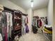 This closet features built in shelving, hanging racks, carpet flooring and ample storage space at 4220 Sawgrass Dr, Lithonia, GA 30038