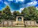 Elegant community entrance with stone accents, a water feature, and lush landscaping, creating a welcoming arrival at 4220 Sawgrass Dr, Lithonia, GA 30038