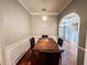 Dining area featuring dark wood table, hardwood floors, and modern light fixture at 4220 Sawgrass Dr, Lithonia, GA 30038