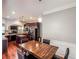 Dining area with hardwood floors, dark wood table, and adjacent kitchen at 4220 Sawgrass Dr, Lithonia, GA 30038