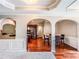 Dining area with hardwood flooring, trim, and arched entry to kitchen at 4220 Sawgrass Dr, Lithonia, GA 30038