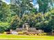 Elegant community entrance featuring brick signage and water features surrounded by lush landscaping at 4220 Sawgrass Dr, Lithonia, GA 30038