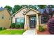 Inviting front entrance with a brick facade, manicured landscaping, and a sidewalk at 4220 Sawgrass Dr, Lithonia, GA 30038