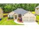 Charming brick home with a well-manicured lawn and a two-car garage at 4220 Sawgrass Dr, Lithonia, GA 30038