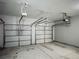 Spacious three car garage features three overhead doors with openers, ready for vehicles and storage at 4220 Sawgrass Dr, Lithonia, GA 30038