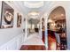 Hallway featuring hardwood flooring, trim molding, archways and artwork at 4220 Sawgrass Dr, Lithonia, GA 30038