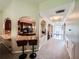Hallway with carpet and arches leading to the kitchen and front door at 4220 Sawgrass Dr, Lithonia, GA 30038