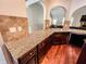 Kitchen area featuring granite countertops, hardwood floors, and dark wood cabinets at 4220 Sawgrass Dr, Lithonia, GA 30038