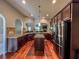 Open concept kitchen features a central island, stainless steel appliances and hard wood floors at 4220 Sawgrass Dr, Lithonia, GA 30038