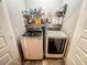 Bright laundry room features a washer and dryer with ample storage shelving above for detergents and supplies at 4220 Sawgrass Dr, Lithonia, GA 30038
