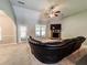 This living room features carpet flooring, a ceiling fan, a brick fireplace, and a large window at 4220 Sawgrass Dr, Lithonia, GA 30038