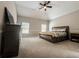Spacious main bedroom with tray ceilings, carpet, and plenty of natural light at 4220 Sawgrass Dr, Lithonia, GA 30038