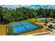 Aerial view features well-maintained community tennis courts surrounded by lush greenery, promoting an active lifestyle at 4220 Sawgrass Dr, Lithonia, GA 30038