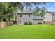 Spacious backyard with a large lawn, privacy fence, and a two-story home with a patio at 4800 Countryside E, Stone Mountain, GA 30083