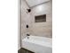 Bathroom featuring a white tub, recessed storage cubby, and black fixtures at 4800 Countryside E, Stone Mountain, GA 30083