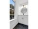 Bright bathroom with a window view, modern vanity, and black hardware accents at 4800 Countryside E, Stone Mountain, GA 30083
