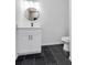 Contemporary bathroom featuring a new vanity, round mirror, and modern toilet at 4800 Countryside E, Stone Mountain, GA 30083