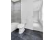 Contemporary bathroom with a toilet, gray tiled walls, and access to bedroom at 4800 Countryside E, Stone Mountain, GA 30083