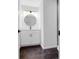 Modern bathroom featuring a white vanity, round mirror, and contemporary lighting at 4800 Countryside E, Stone Mountain, GA 30083