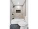 Remodeled bathroom featuring a new shower with modern tile work and black trim at 4800 Countryside E, Stone Mountain, GA 30083