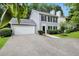 A delightful two-story house with a two-car garage, complemented by a lush green lawn and mature landscaping at 4800 Countryside E, Stone Mountain, GA 30083