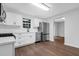 A modern kitchen with stainless steel appliances, white cabinets, and dark hardwood flooring at 4800 Countryside E, Stone Mountain, GA 30083