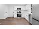 Open-concept kitchen with stainless steel appliances, white cabinets and hardwood floors at 4800 Countryside E, Stone Mountain, GA 30083