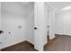 Clean laundry room with new hardwood floors, white walls, and modern appliances at 4800 Countryside E, Stone Mountain, GA 30083