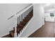 Beautiful staircase featuring rod iron spindles and wood stairs with new hardwood floors at 4800 Countryside E, Stone Mountain, GA 30083