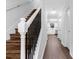 Beautiful staircase featuring rod iron spindles and wood stairs with new hardwood floors at 4800 Countryside E, Stone Mountain, GA 30083