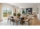 Dining room and living room featuring hardwood flooring and a sliding glass door to the outdoor living space at 7225 Lacey Lot 147 Dr, Douglasville, GA 30134