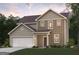 Charming two-story home with a covered front porch, manicured lawn, and an attached garage at 7225 Lacey Lot 147 Dr, Douglasville, GA 30134