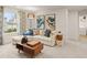 Cozy living room with a sectional sofa, stylish decor, and a large window overlooking the community at 7225 Lacey Lot 147 Dr, Douglasville, GA 30134