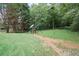 Spacious yard with playset surrounded by lush greenery at 7720 Paddocks Mill Dr, Cumming, GA 30041