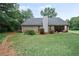 Large backyard featuring a patio, lush lawn, and ample space for outdoor activities at 7720 Paddocks Mill Dr, Cumming, GA 30041