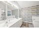This primary bathroom features a double sink vanity, soaking tub, and shower in an updated space at 7720 Paddocks Mill Dr, Cumming, GA 30041