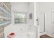 The bathroom features a soaking tub under a window and a glass shower with white tiling and a small tiled wall at 7720 Paddocks Mill Dr, Cumming, GA 30041