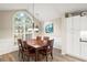 Charming dining area with large arched window, wood table, and wainscoting, perfect for Gathering meals at 7720 Paddocks Mill Dr, Cumming, GA 30041