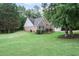 Brick home exterior with green lawn and shrubbery at 7720 Paddocks Mill Dr, Cumming, GA 30041