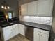 Modern kitchen featuring sleek black countertops, stainless steel appliances, and white cabinetry at 7720 Paddocks Mill Dr, Cumming, GA 30041