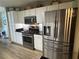 Updated kitchen with stainless steel appliances, stylish backsplash, and modern fixtures at 7720 Paddocks Mill Dr, Cumming, GA 30041