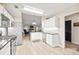 Updated kitchen and living area with modern appliances, white cabinetry, and open layout to the dining area at 7720 Paddocks Mill Dr, Cumming, GA 30041