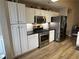 Well-appointed kitchen with stainless steel appliances, white cabinets, and modern finishes at 7720 Paddocks Mill Dr, Cumming, GA 30041
