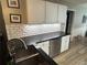 Kitchen featuring white cabinets, granite countertops, stainless steel dishwasher, and tile backsplash at 7720 Paddocks Mill Dr, Cumming, GA 30041